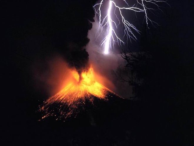 Photograph of a volcanic eruption amidst lightening