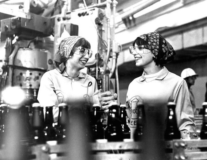 Photo of Laverne and Shirley at wok among an assembly line.