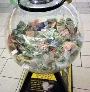 Foreign currency donations in a spherical bowl