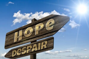 Signs pointing in opposite directions to Hope and Despair