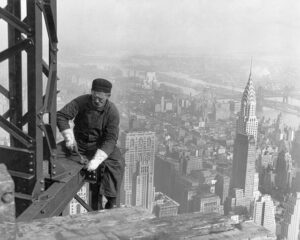 Black & white photo of man working on a skyscraper