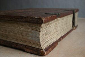 Close up of a very old volume of a book with scuff marks.