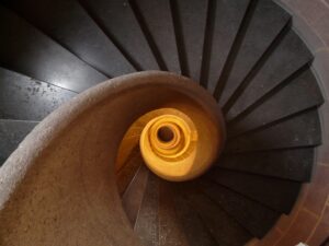 Looking down on a spiral staircase that resembles a seashell.