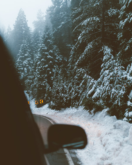 A snow-covered road in the mountains.
