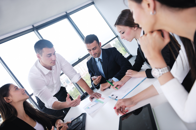 Group of happy young business people in a meeting at office