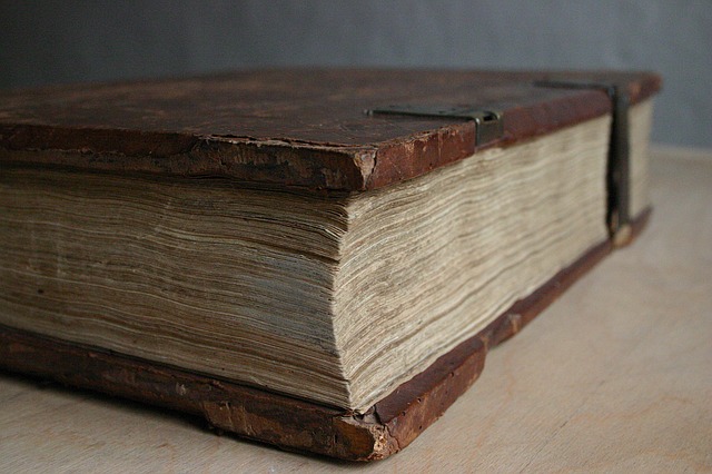 Close up of a very old volume of a book with scuffs.