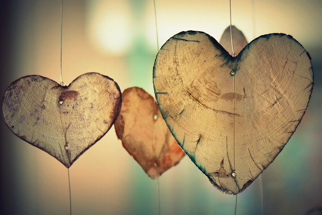 Wooden pieces in the shape of hearts hung vertically.