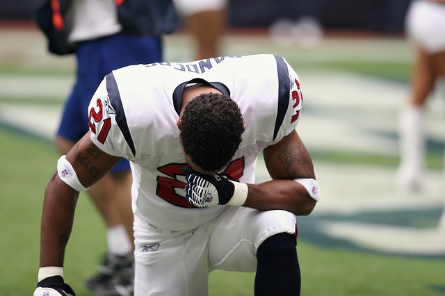 A football player kneeling.