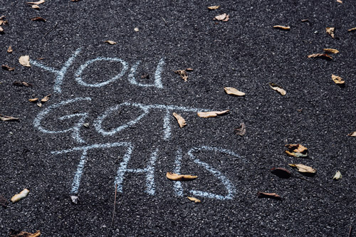 Writing in chalk on the pavement, You Got This, in response to being chosen by God.