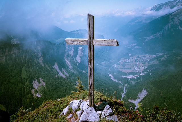 A wooden cross on a mountaintop
